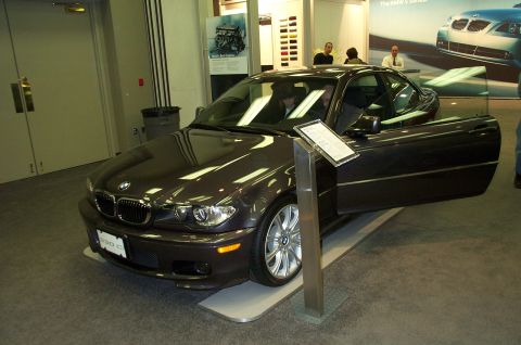 2001 Ford Crown Victoria - BMW 330Ci coupe on display at an auto show, door open for viewing.
