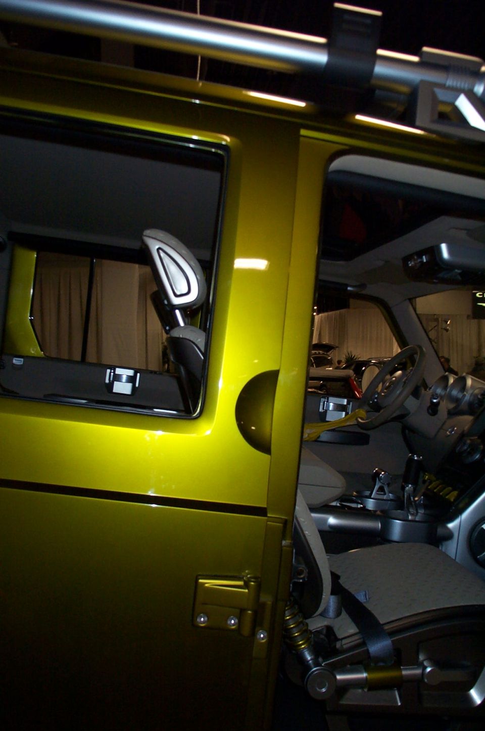 Yellow SUV interior with exposed roll cage, unique dashboard, and bucket seats