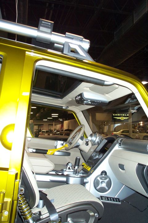 2001 Ford Crown Victoria - Interior view of a yellow concept SUV, a unique dashboard and roof-mounted accessory.