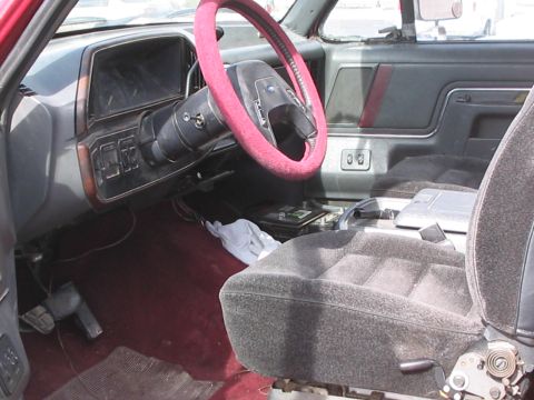 1991 Ford Bronco - Interior view of a 1991 Ford Bronco, showing the dashboard, steering wheel, and front seats.