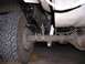 1989 Ford Bronco - Close-up of the rear suspension on a 1989 Ford Bronco, indicating a lift kit installation.