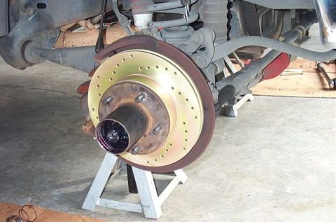 1995 Ford Bronco - Front brake rotor and hub assembly on jack stands, hub is greased.