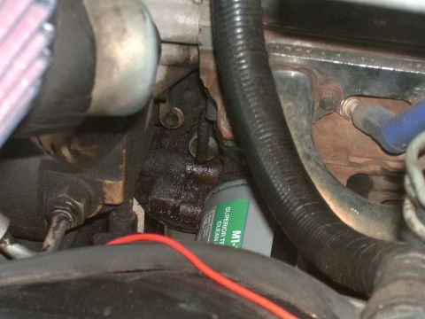 1989 Ford Bronco - Close-up view of engine components, including an oil filter and hoses.