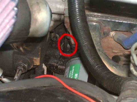 1989 Ford Bronco - Close-up view of an engine component highlighted with a red circle, showing an oil filter and various hoses.
