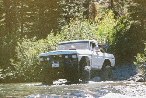 1994 Ford Bronco - This 1978 Ford F-150 is navigating a rocky stream bed surrounded by trees.
