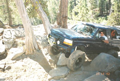 1994 Ford Bronco - This 1994 Ford Bronco is shown off-roading through a challenging rocky landscape.