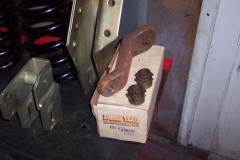 1990 Ford Bronco - Suspension components including coil springs, a rusty bracket, and bushings from Trail Suspensions.