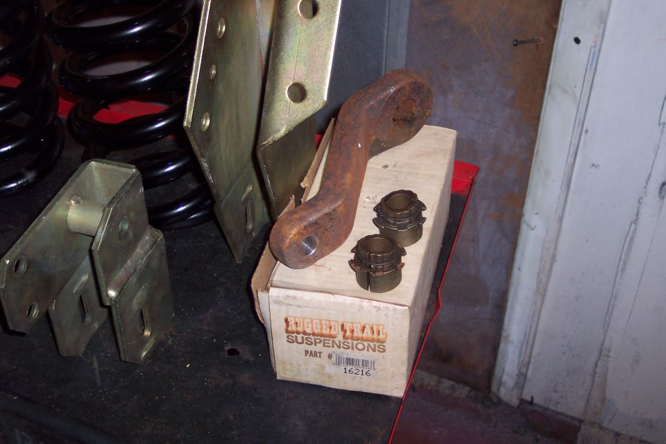 Box of Trail Suspensions parts with rusty metal bracket and coil springs