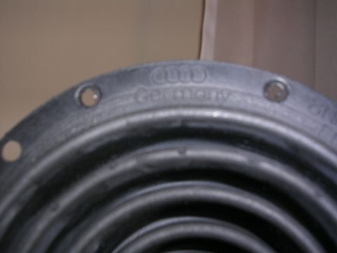 2003 Chevrolet Monte Carlo - Close-up of a part with embossed text indicating it is from Audi and made in Germany.