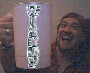 1989 Ford Bronco - A man joyfully holds up a cup with "WISKEY" written on it, with the Supermotors logo in the corner.