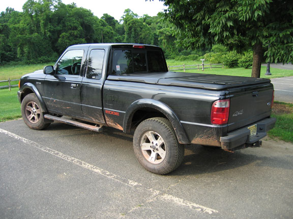 Black 2002 Ford Ranger pickup truck with an "EDGE" badge on the fender