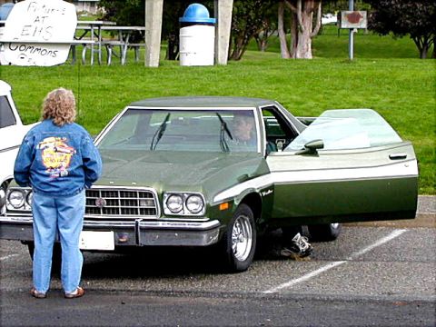 1967 Ford Ranchero - A 1977 Ford Ranchero pickup truck is parked with its driver's side door open.