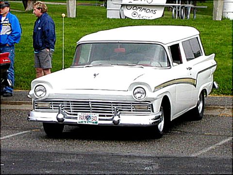 1967 Ford Ranchero - White 1957 Ford Fairlane 500 Town Victoria parked, with two men standing nearby.