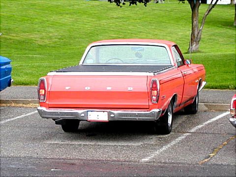 1967 Ford Ranchero - Rear view of a red 1967 Ford Ranchero pickup truck parked in a lot.