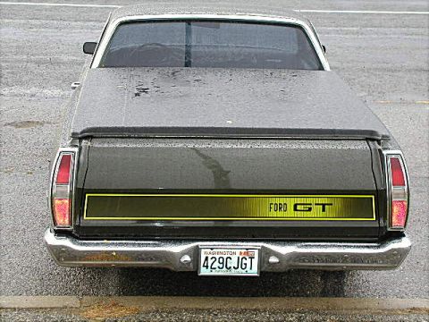 1967 Ford Ranchero - The rear of a 1967 Ford Ranchero GT shows the 'FORD GT' badging on a yellow stripe.
