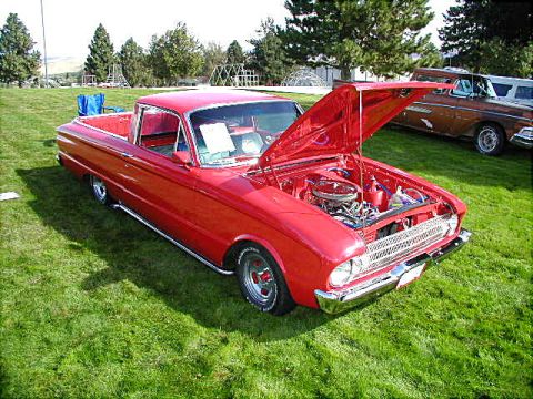 1967 Ford Ranchero - A red 1960 Ford Ranchero is displayed with its hood open, showing the engine bay.