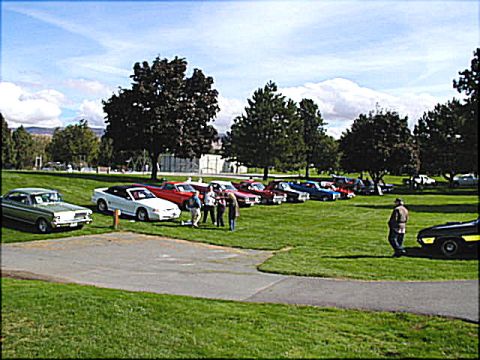 1967 Ford Ranchero - An outdoor car show displays a variety of vehicles under a partly cloudy sky.