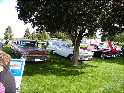 1967 Ford Ranchero - A collection of vintage vehicles are displayed on a grassy lawn, with a large tree providing shade.