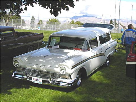 1967 Ford Ranchero - A white 1957 Ford station wagon is parked on a grassy field next to another vehicle.