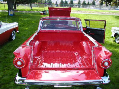 1967 Ford Ranchero - Rear view of a red 1957 Ford Ranchero pickup truck with its hood and driver's door open.