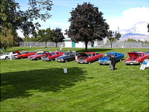 1967 Ford Ranchero - A collection of vintage Ford Rancheros and other classic vehicles are gathered on a grassy field for an outdoor show.