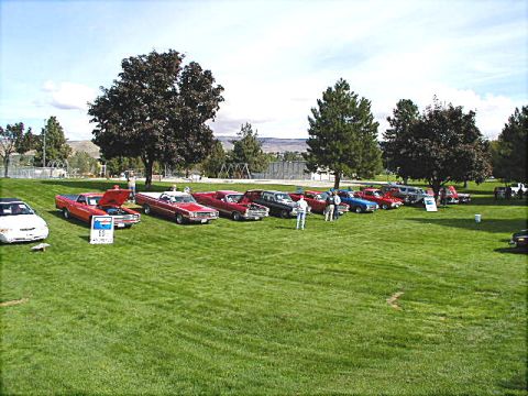 1967 Ford Ranchero - A collection of classic Ford Rancheros and other vehicles are displayed on a sunny day at an outdoor event.