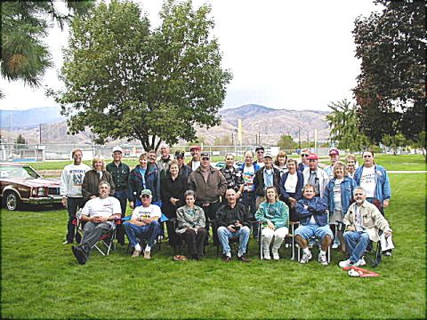 1967 Ford Ranchero - A group of people pose for a photo in a park, with a car visible on the left side.