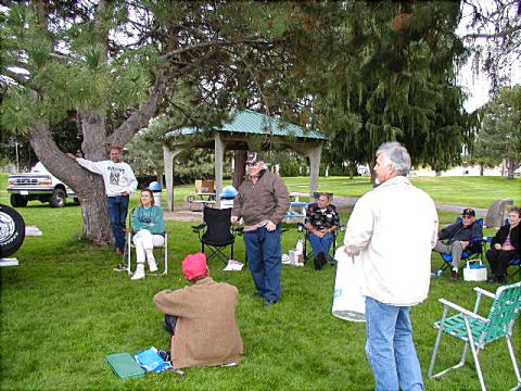 1967 Ford Ranchero - A white Ford pickup truck is parked in a park setting with people gathered around.