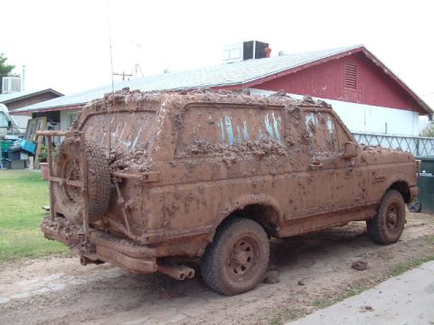 1990 Ford Bronco - This 1990 Ford Bronco is heavily covered in mud, obscuring most details.
