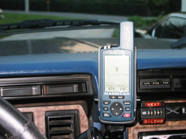 Magellan MAP 330 GPS mounted on a blue dashboard with woodgrain trim