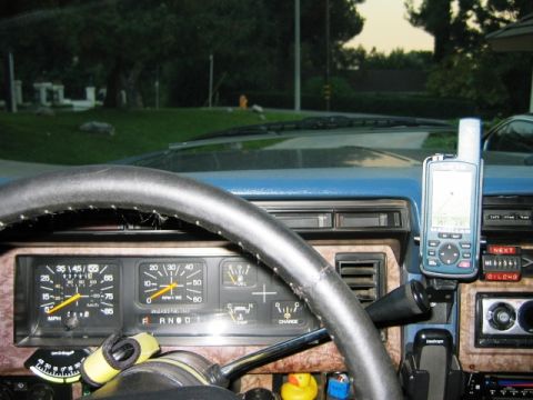 1985 Ford Bronco - Interior view of a vehicle's dashboard, showing the steering wheel, instrument cluster, and a mounted GPS unit.
