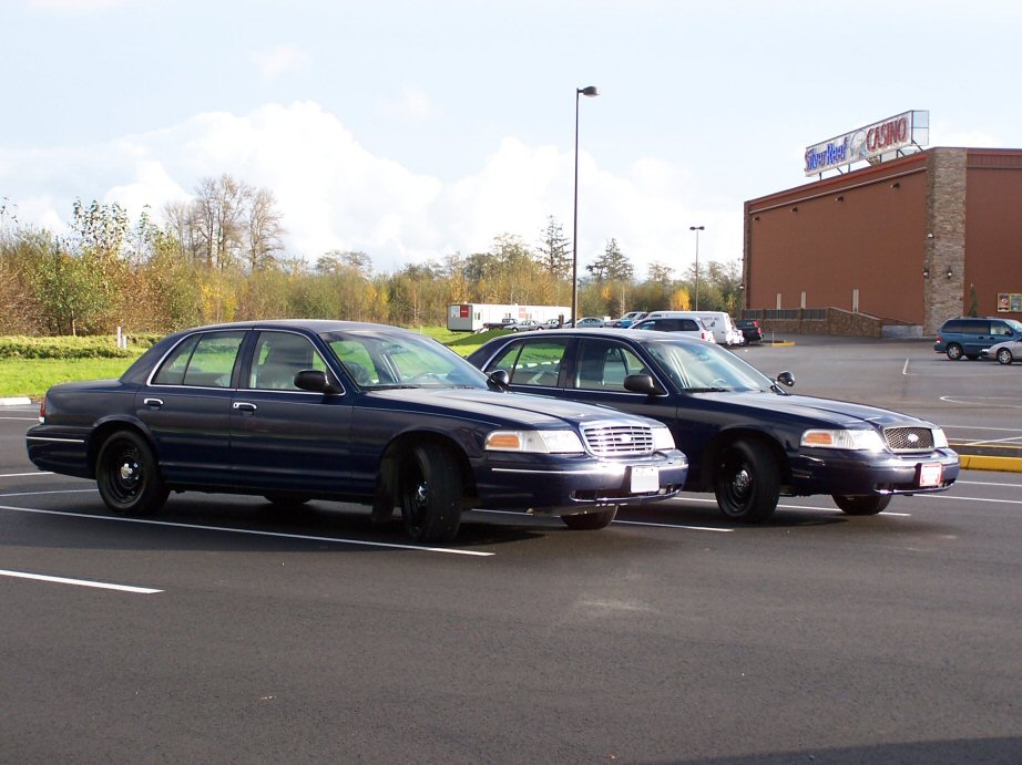 1998 Ford Crown Victoria sedans parked side-by-side in a parking lot