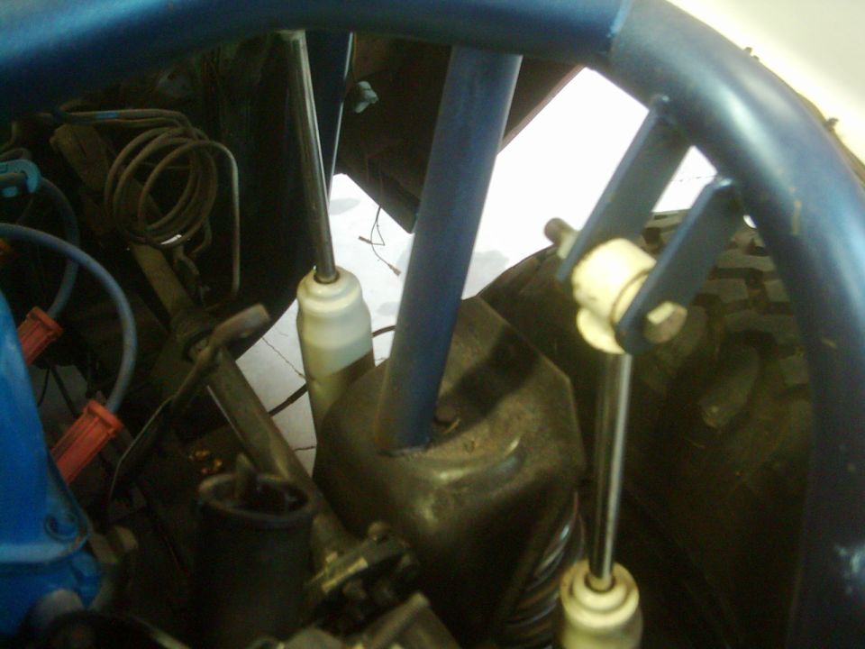 Blue roll cage and suspension parts inside a vehicle