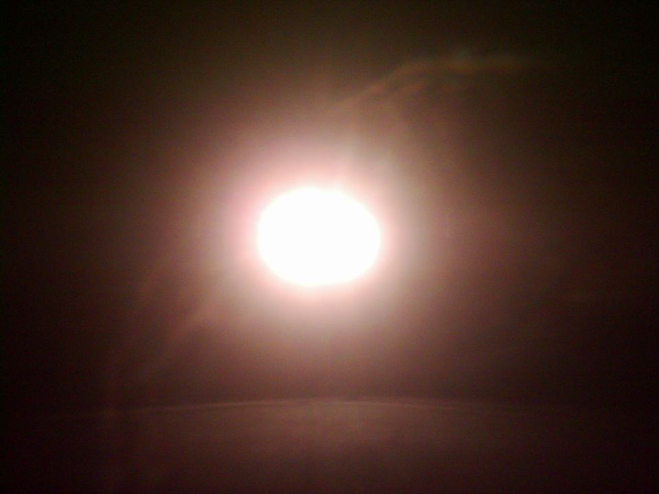 Bright headlight illuminated in darkness, with SUPERMOTORS.NET watermark