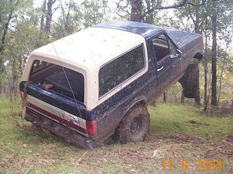 1978 Ford Bronco - This 1978 Ford Bronco is stuck in the mud off-road, tilted on its side.