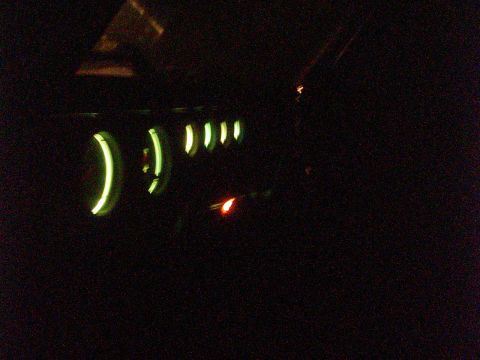 1978 Ford Bronco - The illuminated dashboard gauges are visible in the dark interior of the vehicle.