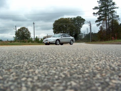 1998 Ford Taurus - A silver 1998 Ford Taurus is shown from a low angle on a cloudy day.