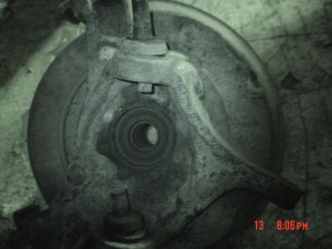 1991 Ford F-150 - This is a close-up view of a vehicle's front wheel hub assembly, showing the bearing and brake rotor backing plate.