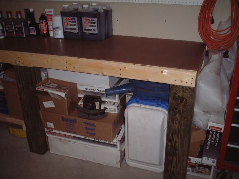 1967 Ford Galaxie - Car parts, junk, etc. neatly crammed underneath the rest of the work bench.