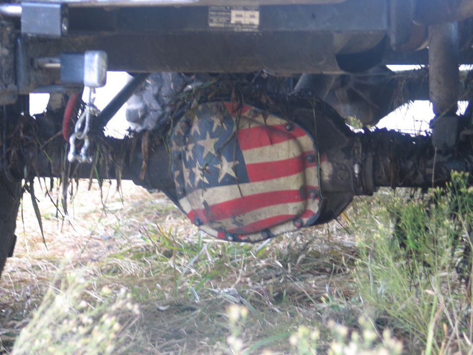 Differential cover painted with American flag stars and stripes under a muddy 4x4