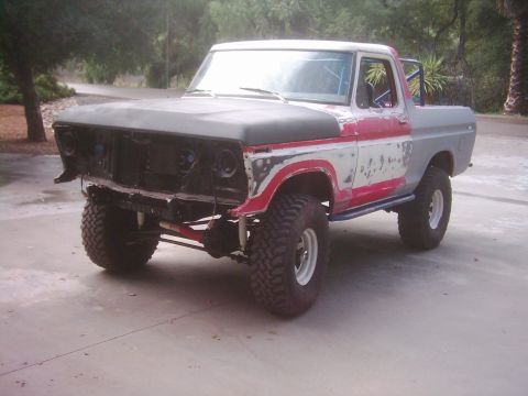 1978 Ford Bronco - This pickup truck is undergoing restoration, with its front end disassembled and bodywork in progress.