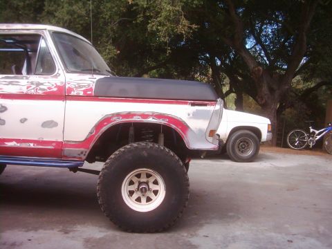 1978 Ford Bronco - A 1978 Ford Bronco is partially visible next to another vehicle and bicycles.