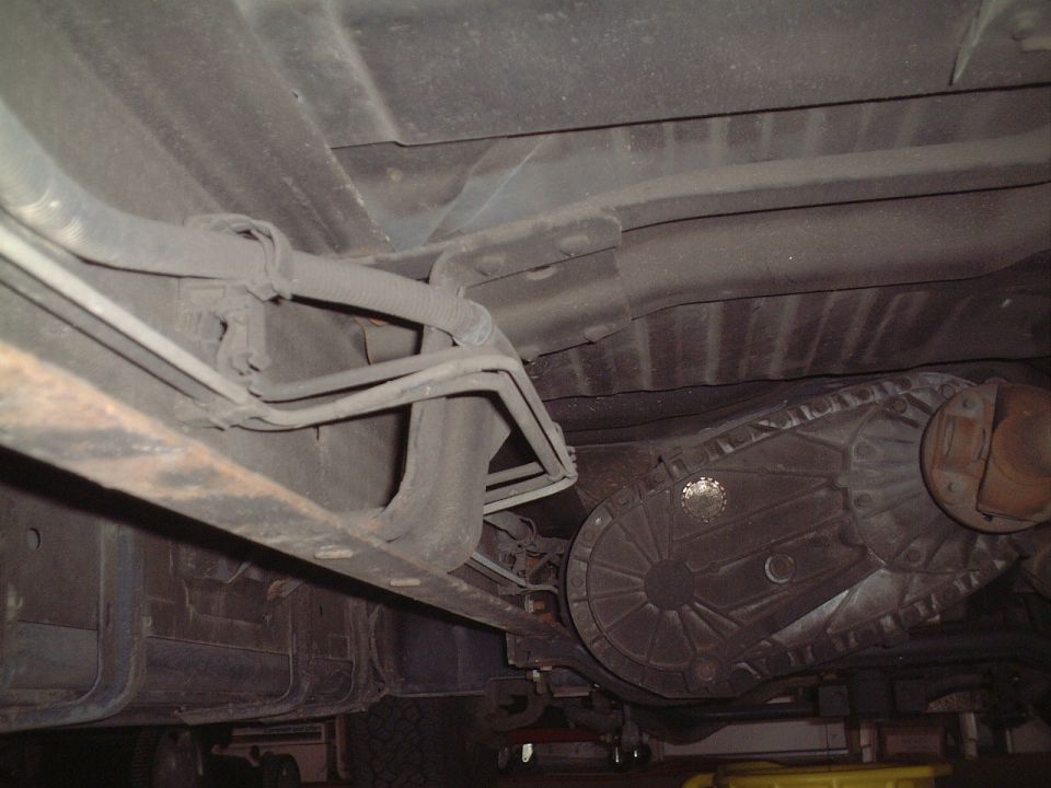Underside view of vehicle transfer case and frame rail