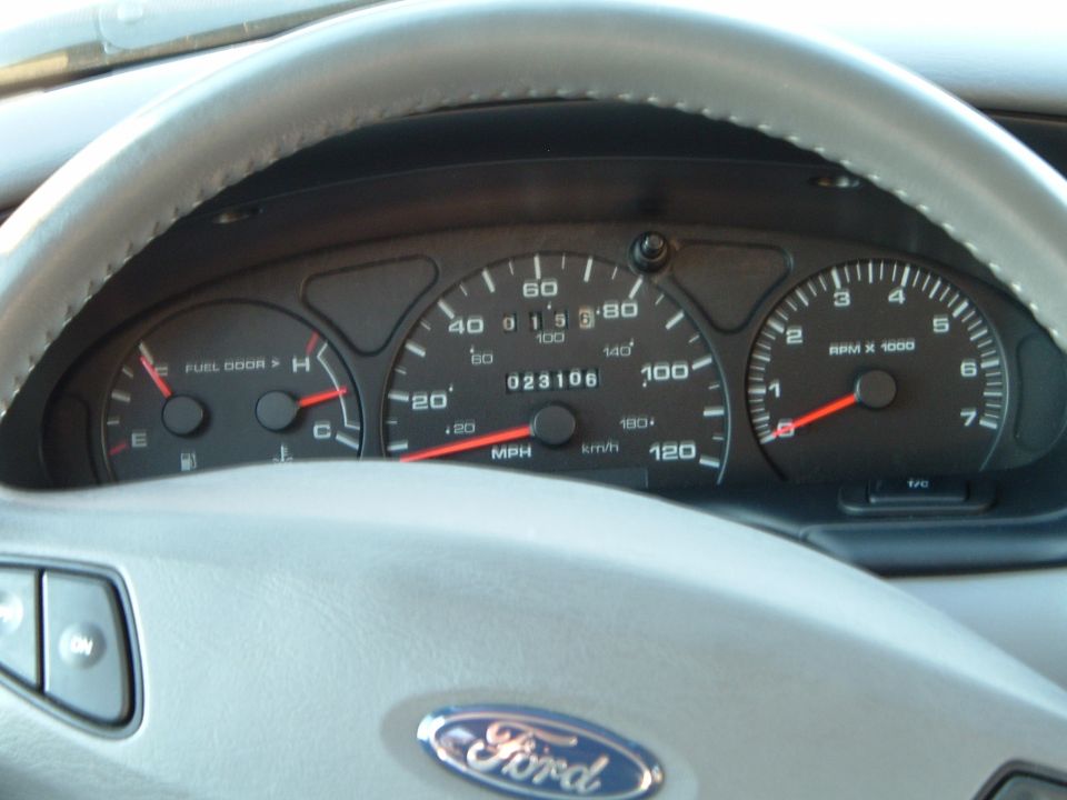 2001 Ford Taurus dashboard with speedometer, tachometer, and fuel gauge visible