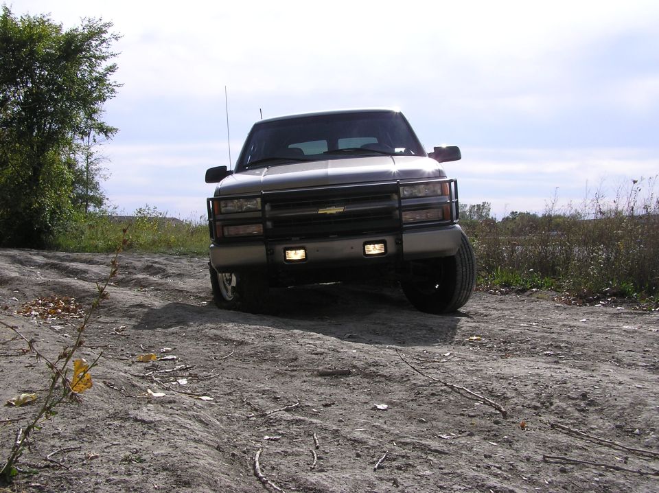 Front view of a silver truck with a brush guard and aftermarket grille