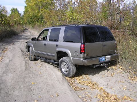 2000 Chevrolet Tahoe - Rear view of a 1999 Chevrolet Tahoe on a dirt road during autumn.