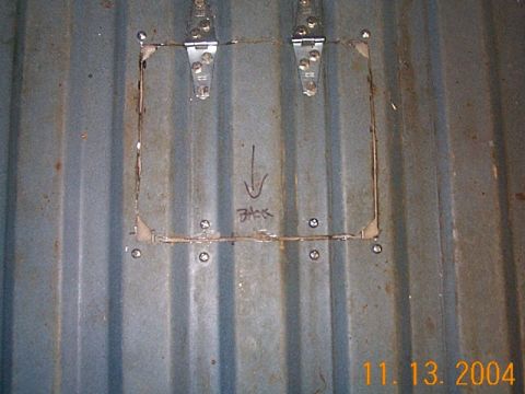 1986 Ford Bronco - A close-up view of a corrugated metal surface with a custom-made, hinged access panel.