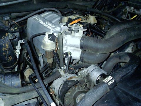 1987 Ford Bronco - Close-up view of the engine compartment, showing various mechanical parts and wiring.