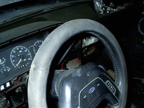 1987 Ford Bronco - The interior of a vehicle shows the dashboard with a speedometer and gear selector.