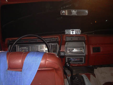 1986 Ford Bronco - Interior view of a car's dashboard, a CB radio and dual-DIN stereo system.